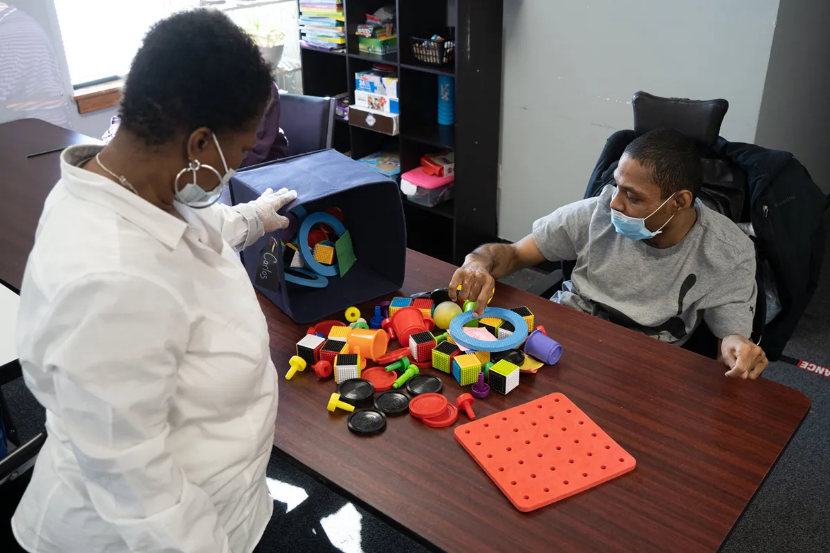 Supportive skill-building activity between caregiver and individual